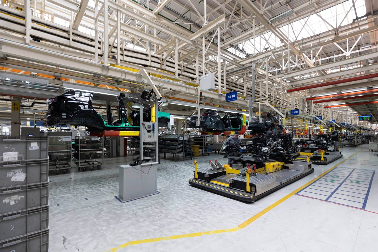 Modern automobile production line with vehicles on assembly track