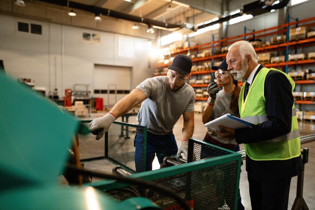 Manufacturing team reviewing component specifications on the factory floor